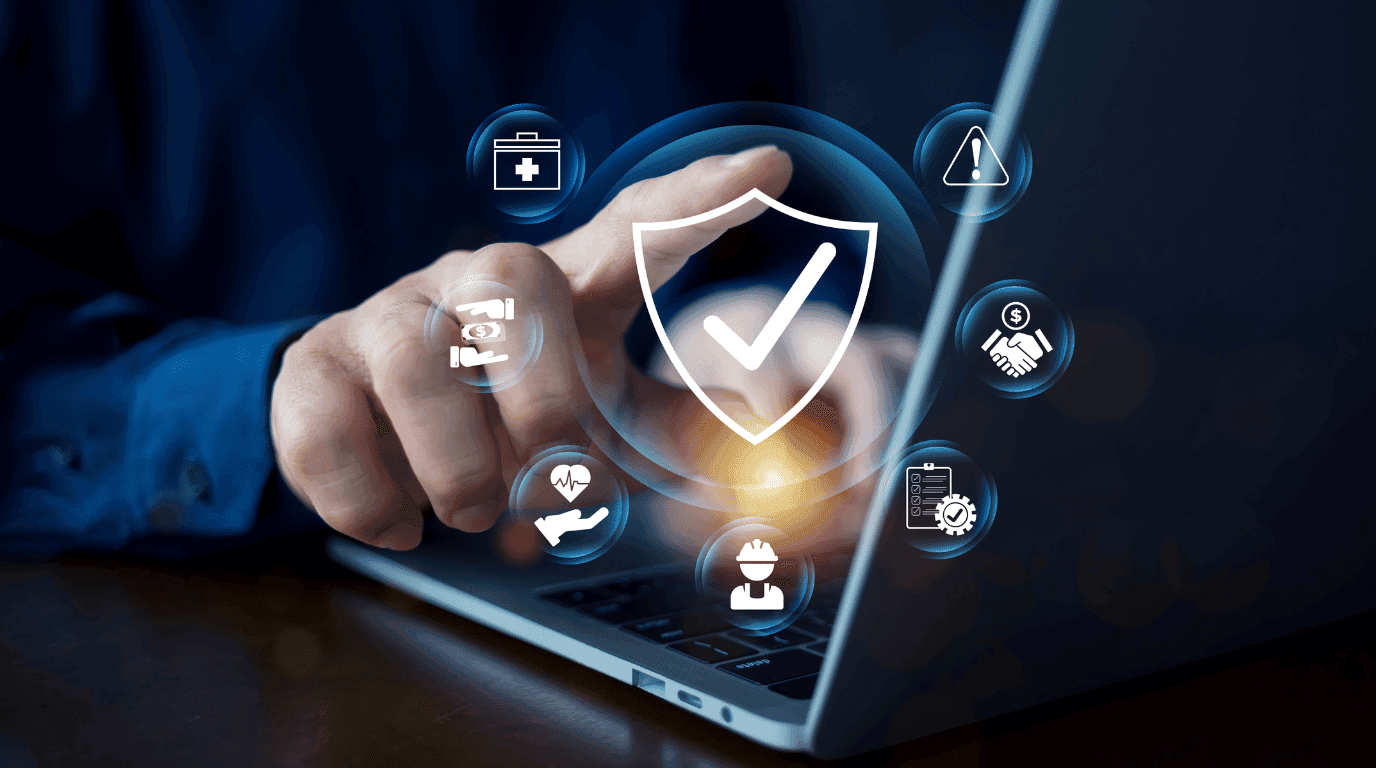 Data protection shield surrounded by compliance icons above a laptop keyboard